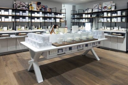 The White Company, Norwich - wooden flooring, white table with white candles in white boxes and jars