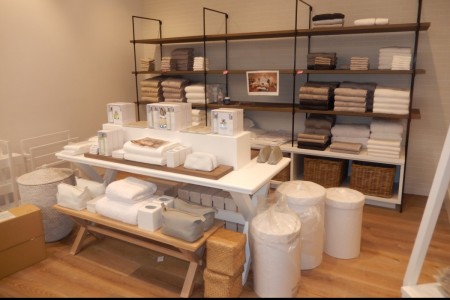 The White Company, Liverpool - white table with accessories, wooden shelves, wooden floor 