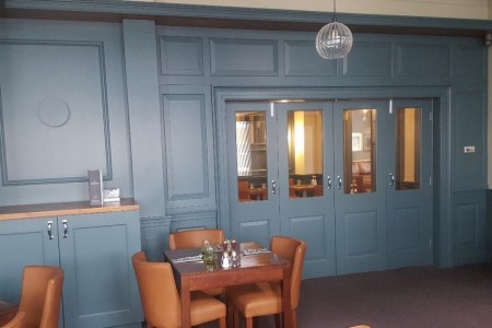 The Chequers Hotel, Newbury - blue panelled walls, wine storage, wooden tables and leather chairs