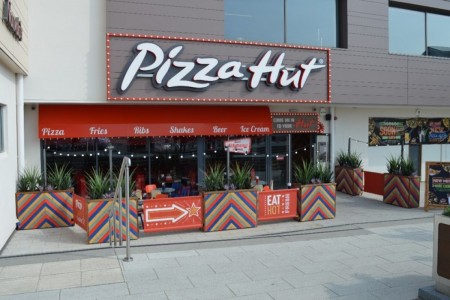 Pizza Hut, Bristol - exterior with seating area, planters and Pizza Hut branding