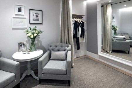 The White Company, Norwich - comfortable seating area outside changing rooms, grey chairs and white table, brown carpet