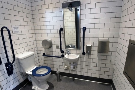 Shake Shack, Leicester Square - white tiling in disabled toilet with accessible features and mirror