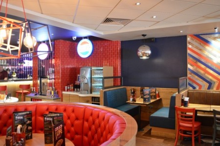 Pizza Hut, Bristol - close of up booth seating with red and blue comfortable seating, geometric lampshades 