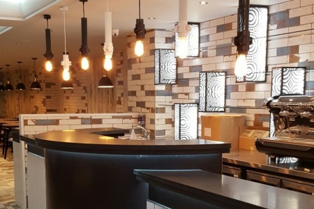 Prezzo, Chippenham - interior with exposed lightbulbs, distressed tiling and curved bar area