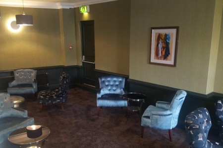The Chequers Hotel, Newbury - seating area with blue chairs and yellow and blue walls