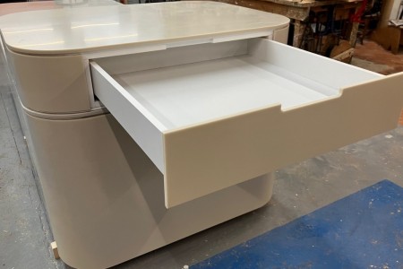 Made of High Macs, a solid surface material, which creates a seamless, sleek finish on this mid floor unit for a high-end retailer in Knightsbridge.