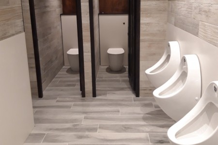 Clark's Village Retail Outlet Public Toilets, Somerset - grey floor and textured wall tiles, white urinals and toilets