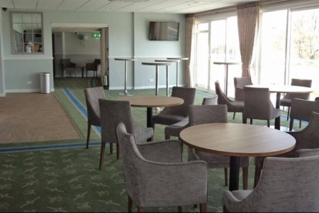 Salisbury Racecourse - bar refurbishment with blue walls, seating area and round tables 