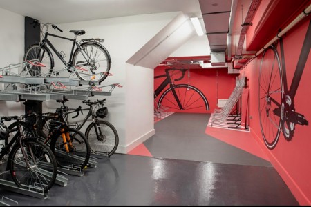 Prudential Buildings, Bristol - red and white walls with bike graphics and to the left a cycle rack with bikes in