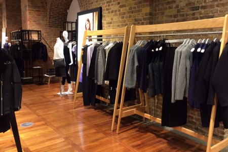 Whistles, St Pancras Station, London - wooden floor and clothes displays, brick walls