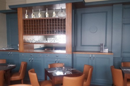 The Chequers Hotel, Newbury - blue panelled walls, wine storage, wooden tables and leather chairs