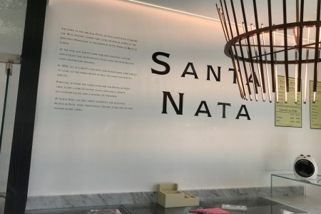 Santa Nata, London - interior with wooden lampshade and white wall with logo and text