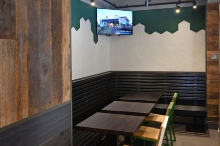 Shake Shack, Leicester Square - tables and chairs, wooden clad walls and white and green tiling