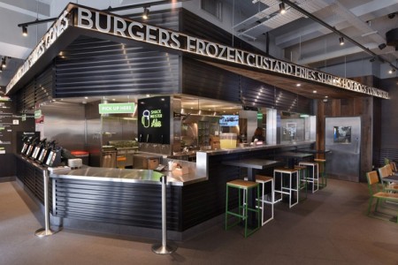 Shake Shack, Leicester Square - dark wooden cladding around point of sale and kitchen area, branding over tills