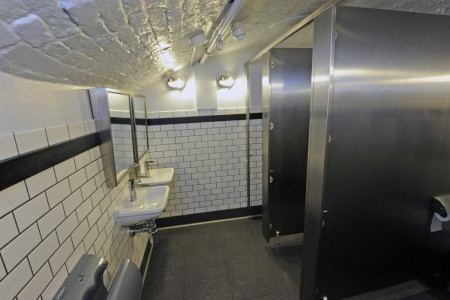 Shake Shack, Covent Garden - toilets with white tiles, grey floor and chrome fittings