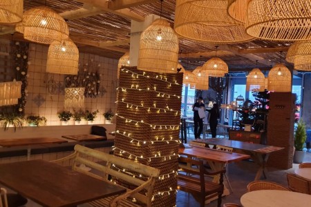 Megan's, Islington - interior with bespoke timber tables and chairs, rope-wrapped pillars, wooden lampshades and fairy lights