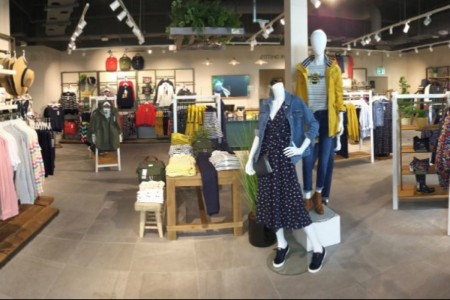 Joules, Longford, Ireland - interior featuring mannequins, grey tiled floor, wooden clothing displays
