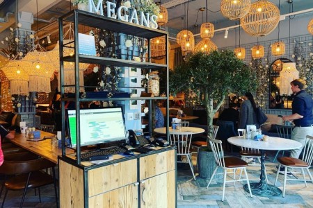 Megan's, Wimbledon - bespoke timber point of sale cabinet from Oakwoods, tables and chairs inside with chic decor