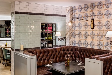 Wildwood, Crawley - brown leather booth seating, blue and white tiled wall behind