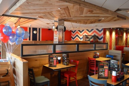 Pizza Hut, Bristol - blue, red and white balloons, wooden accents on ceiling and dividers between tables