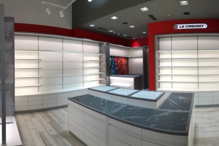 Wide angle view of Le Creuset red cabinetry with light up shelving