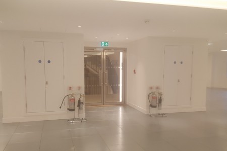 Meyer Bergman, Mayfair - open office space with glass entry doors and fire extinguishers