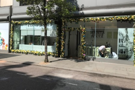 Santa Nata, London - exterior, glass shopfront surrounded by yellow flowers