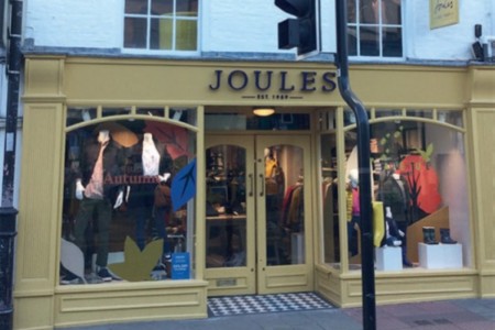 Joules, Ludlow - exterior of shop with yellow painted shopfront and clothing displays in windows