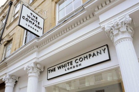 The White Company, Stamford - close up of shop front with logo and details at the top of columns