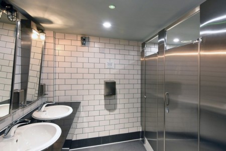Shake Shack, Leicester Square - white tiling in bathroom with chrome doors, white sinks and black worktops, large mirrors 