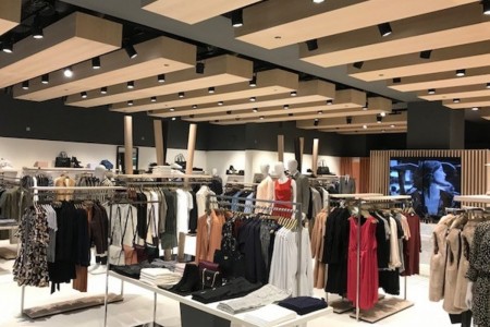 Reiss, Canary Wharf - wooden ceiling details with clothing racks below