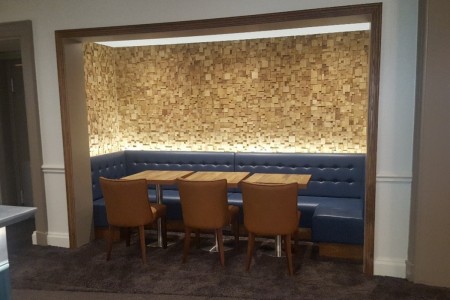 The Chequers Hotel, Newbury - recessed seating area with blue leather seats and wooden tables