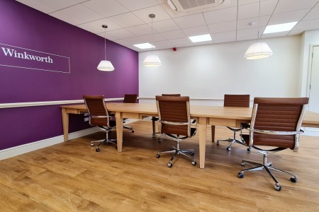 Winkworth Estate Agents, Crystal Palace - large table with leather chairs, purple wall and logo