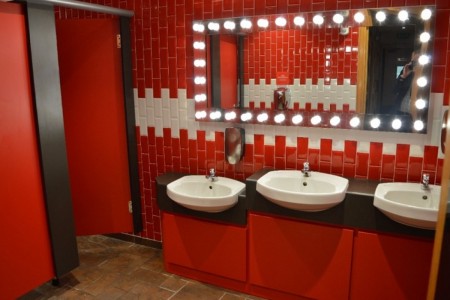Pizza Hut, Bristol - bathroom with red and white tiling, red cabinets and doors, light up mirror and white sinks