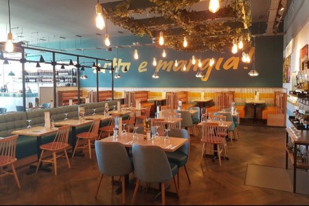 Prezzo, Weston Super Mare - blue walls with wording, wooden tables and chairs, wooden flooring