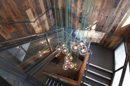 Shake Shack, Leicester Square - looking down stairwell with green wires hanging light bulbs from them with glass shades