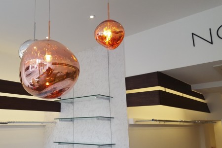 NorieM, London - unique bronze light fittings with glass shelving behind