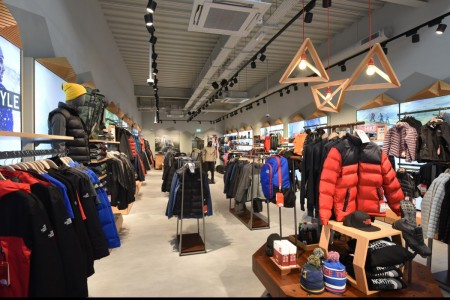 The North Face, Chelmsford - interior with outdoor-type clothing, light boxes on walls and geometric light fittings 