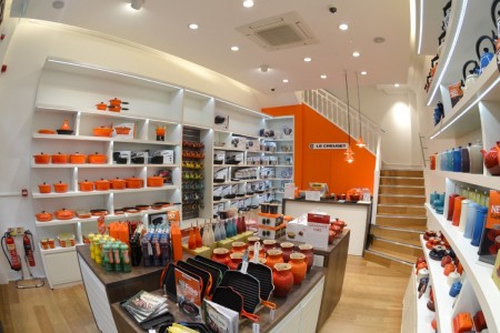 Le Creuset, Leeds - brightly coloured interior with hardwood stairs and floor