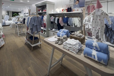 The White Company, Norwich - wooden flooring, tables with baby clothes on
