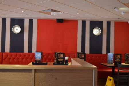 Pizza Hut, Bristol - red, white and blue striped wall with bespoke wooden dividers between booths