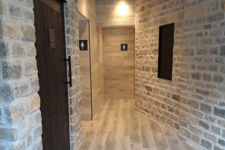 Clark's Village Retail Outlet Public Toilets, Somerset - grey floor and textured wall bricks