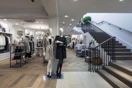 The White Company, Norwich - looking up the wooden stairs with white walls, mannequins at the bottom 