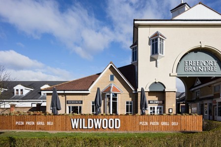 Wildwood, Braintree - exterior of building showing branding and seating area
