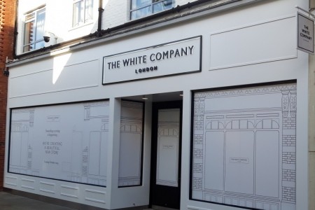 The White Company, Windsor - white exterior of shop with coming soon hoarding up