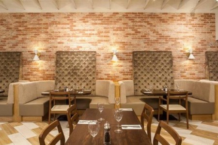 Prezzo, Abergavenny - dark wooden tables and chairs, brick walls, booth seating