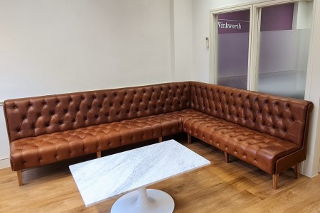 Winkworth Estate Agents, Crystal Palace - brown leather bench seating area, wooden floor and marble coffee table