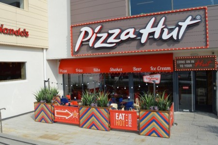 Pizza Hut, Bristol - exterior with planters, outdoor seating and red and white logo