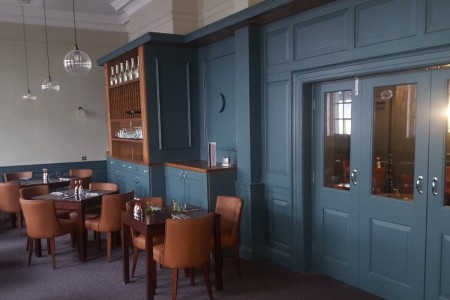 The Chequers Hotel, Newbury - blue panelling on walls and blue doors, wooden tables and chairs