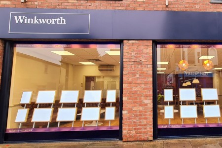 Winkworth Estate Agents, Crystal Palace - exterior with advertising boards I window and brickwork, purple signage and logo 